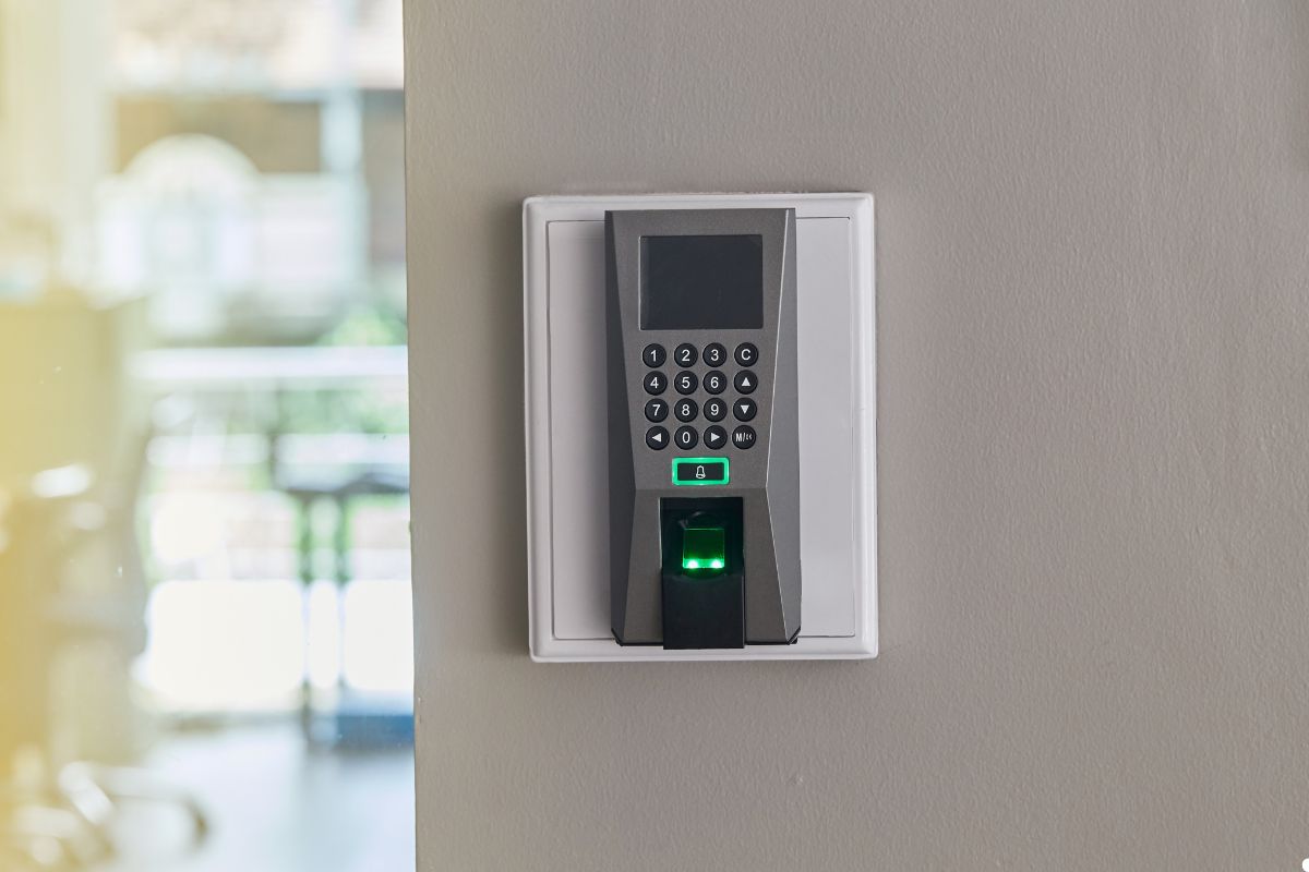 A digital keypad mounted on a wall, featuring a numeric display and buttons for user input. 