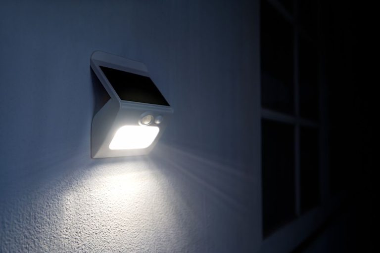 A white light illuminates a wall, activated by motion sensors for enhanced visibility and security.